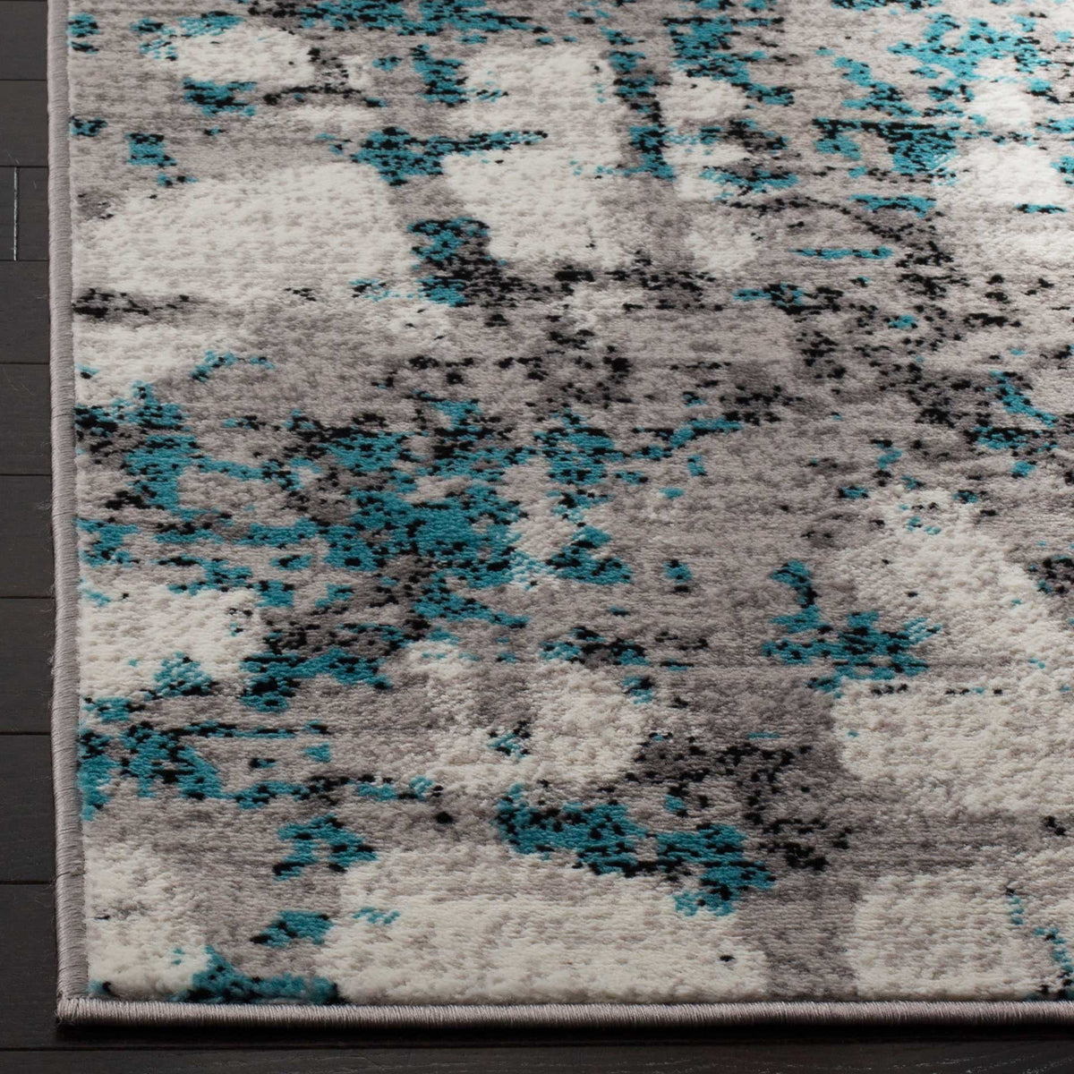 Teal accents and charcoal flecks enliven the soft pile and neatly bound corner