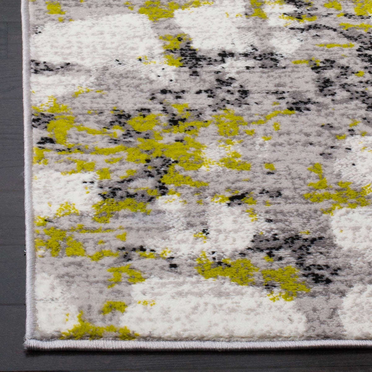 Yellow-green markings contrast with charcoal flecks and a neatly bound corner