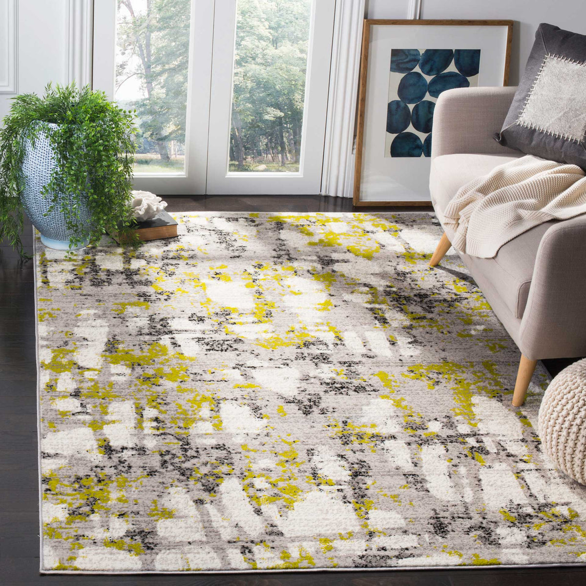 Gray and yellow-green abstract rug adds energetic color beneath a neutral sofa