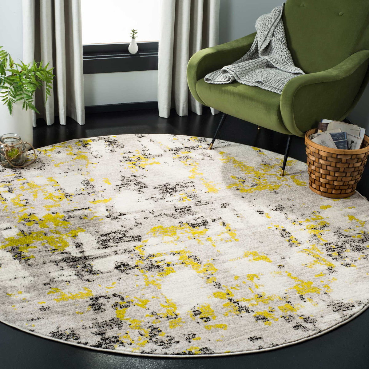 Bright yellow-green accents add energy to the distressed gray pattern of this round rug.