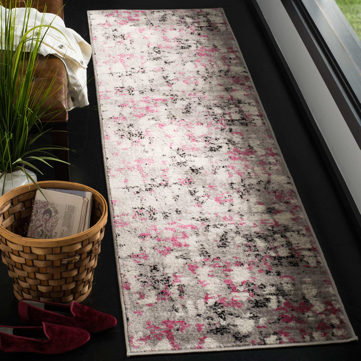 Vibrant pink accents and dark painterly marks give this gray runner a playful feel