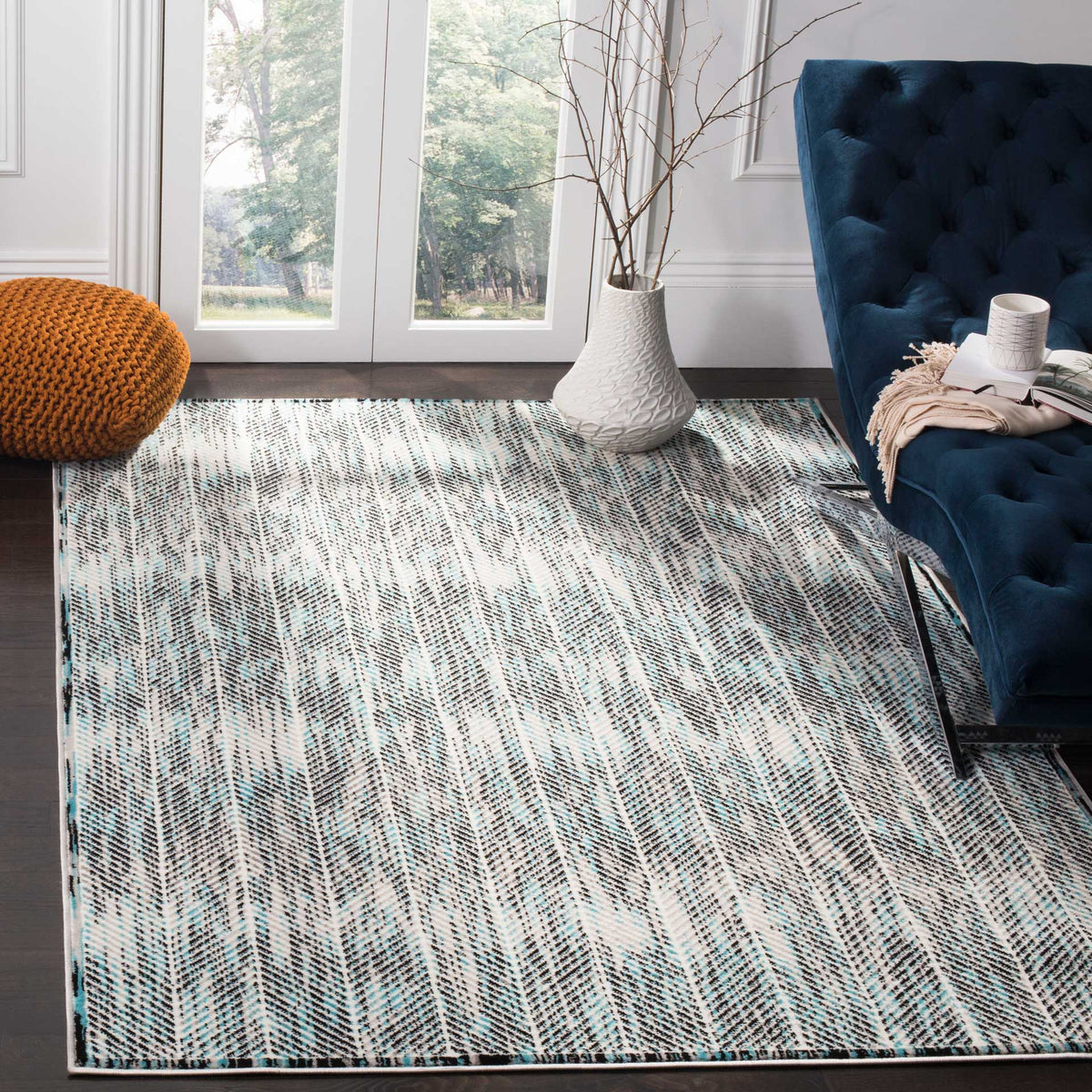 Gray and blue chevrons bring a lively pattern beneath a navy sofa