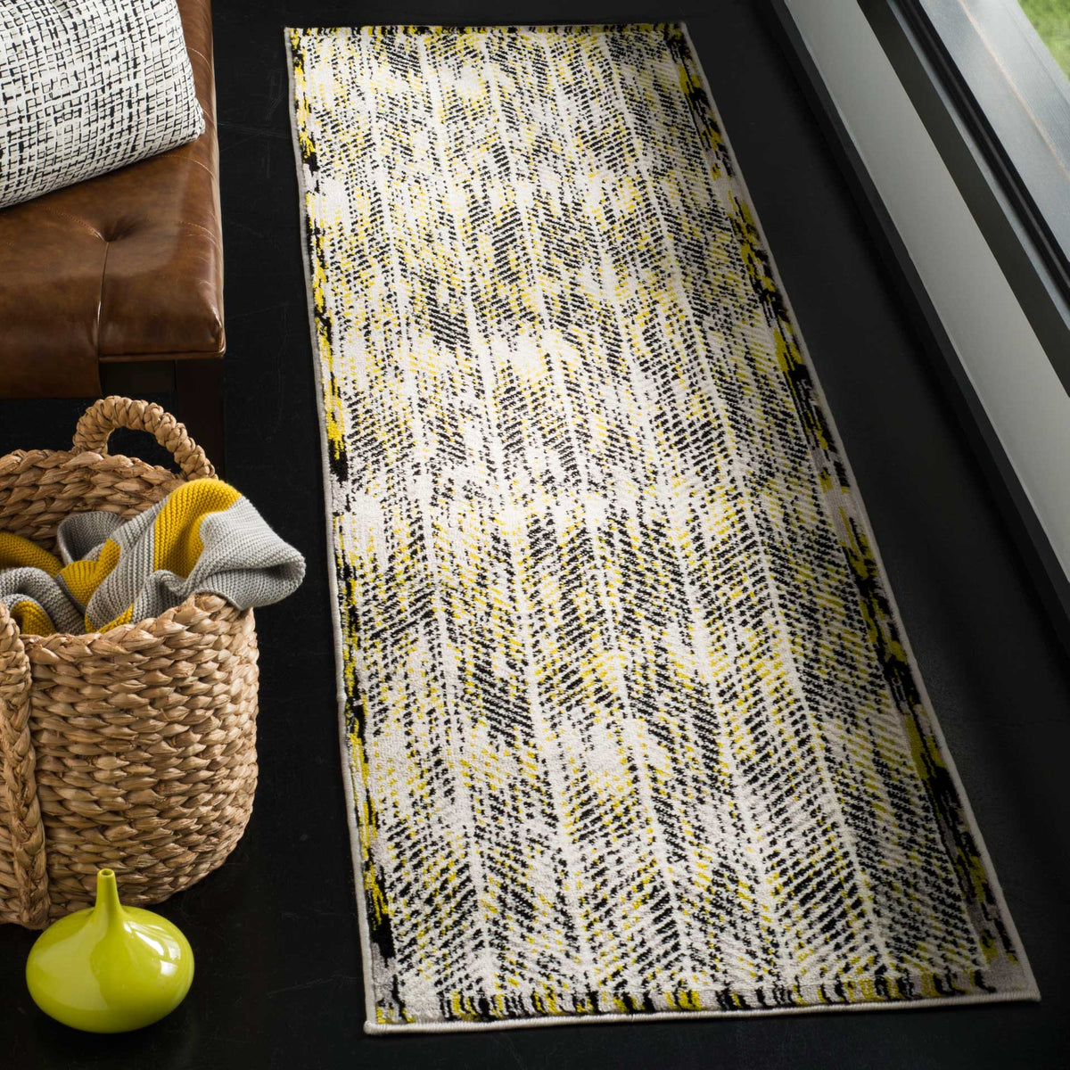 Green accents animate this gray-and-white runner rug, adding graphic texture to narrow spaces