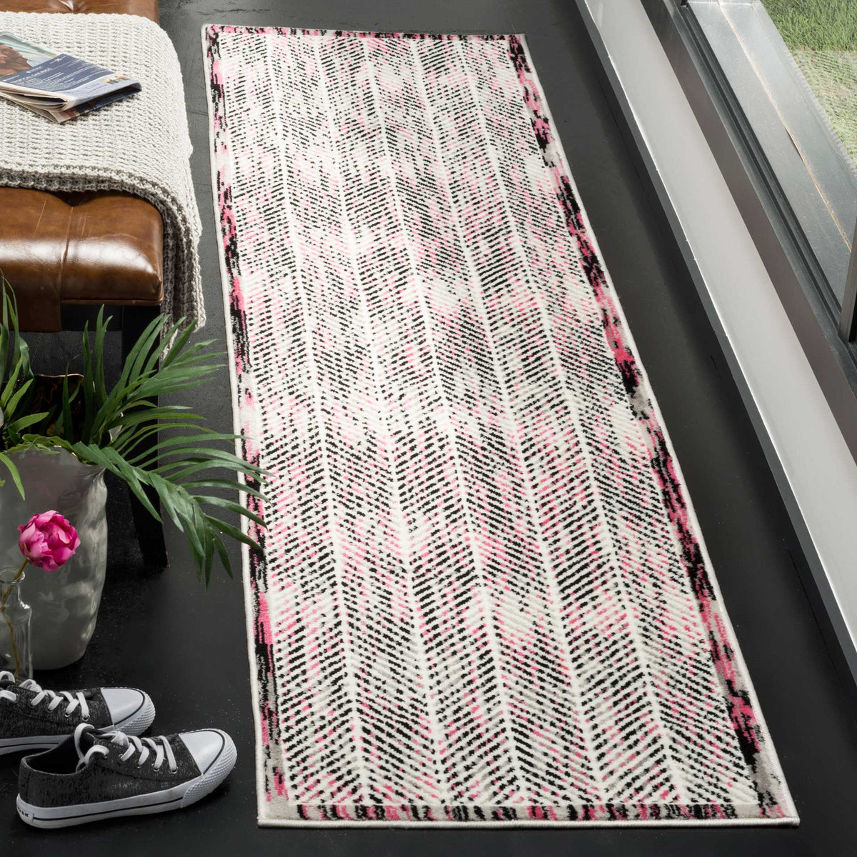 Pink accents brighten this gray-and-white runner rug with a striking abstract pattern