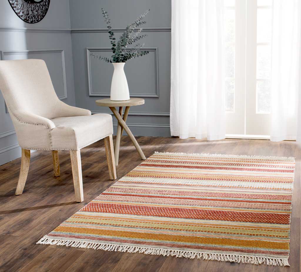 Warm stripes and soft fringe bring color and texture to a light-filled living space