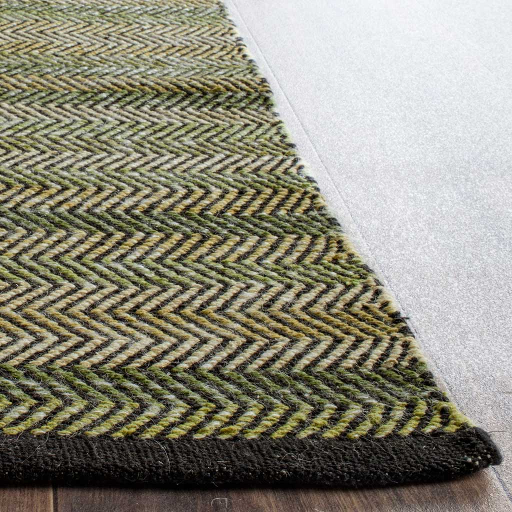 Layered green chevrons and a dark woven edge give this cotton rug tactile appeal