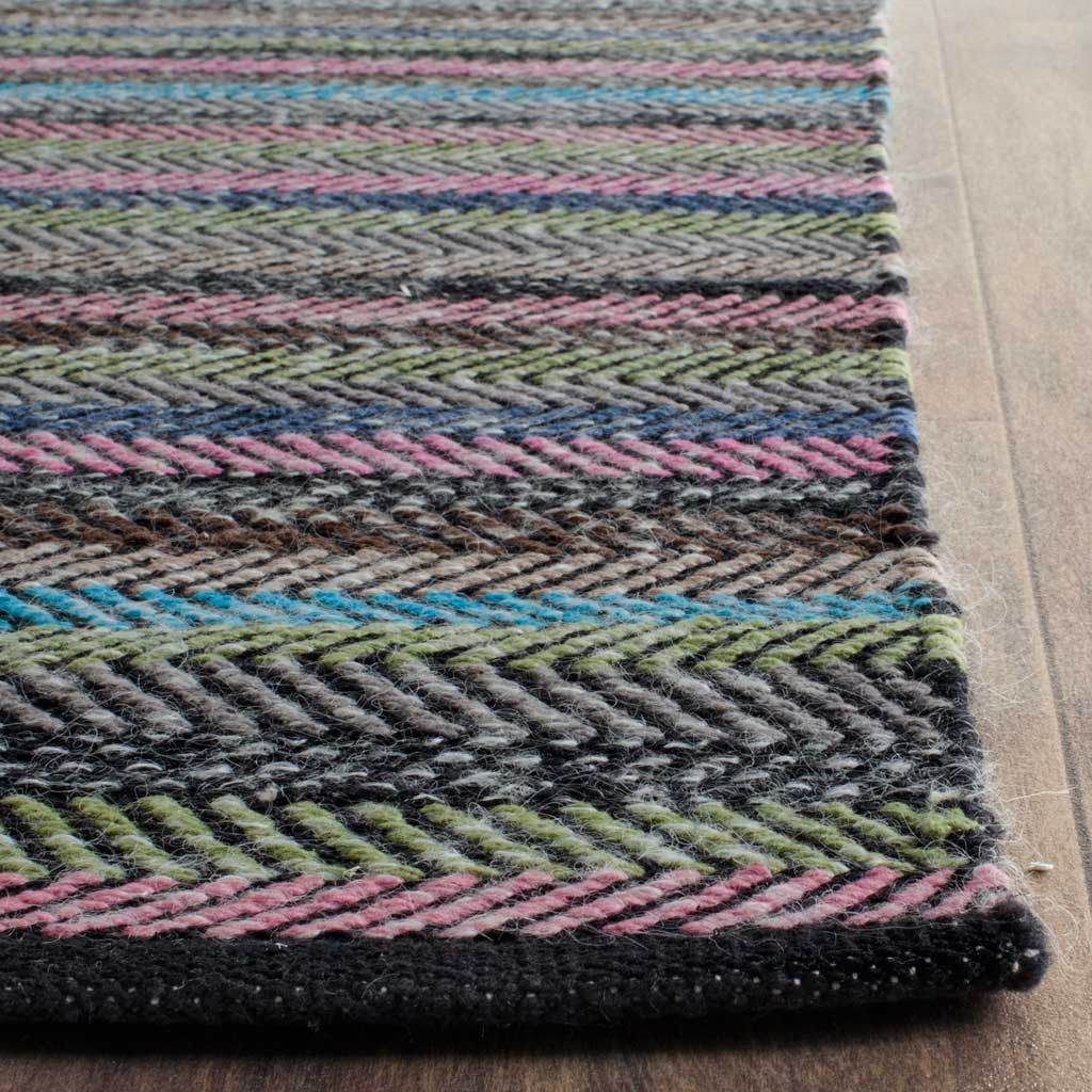 Pink, blue, and green herringbone stripes meet a dark woven edge on this textured rug