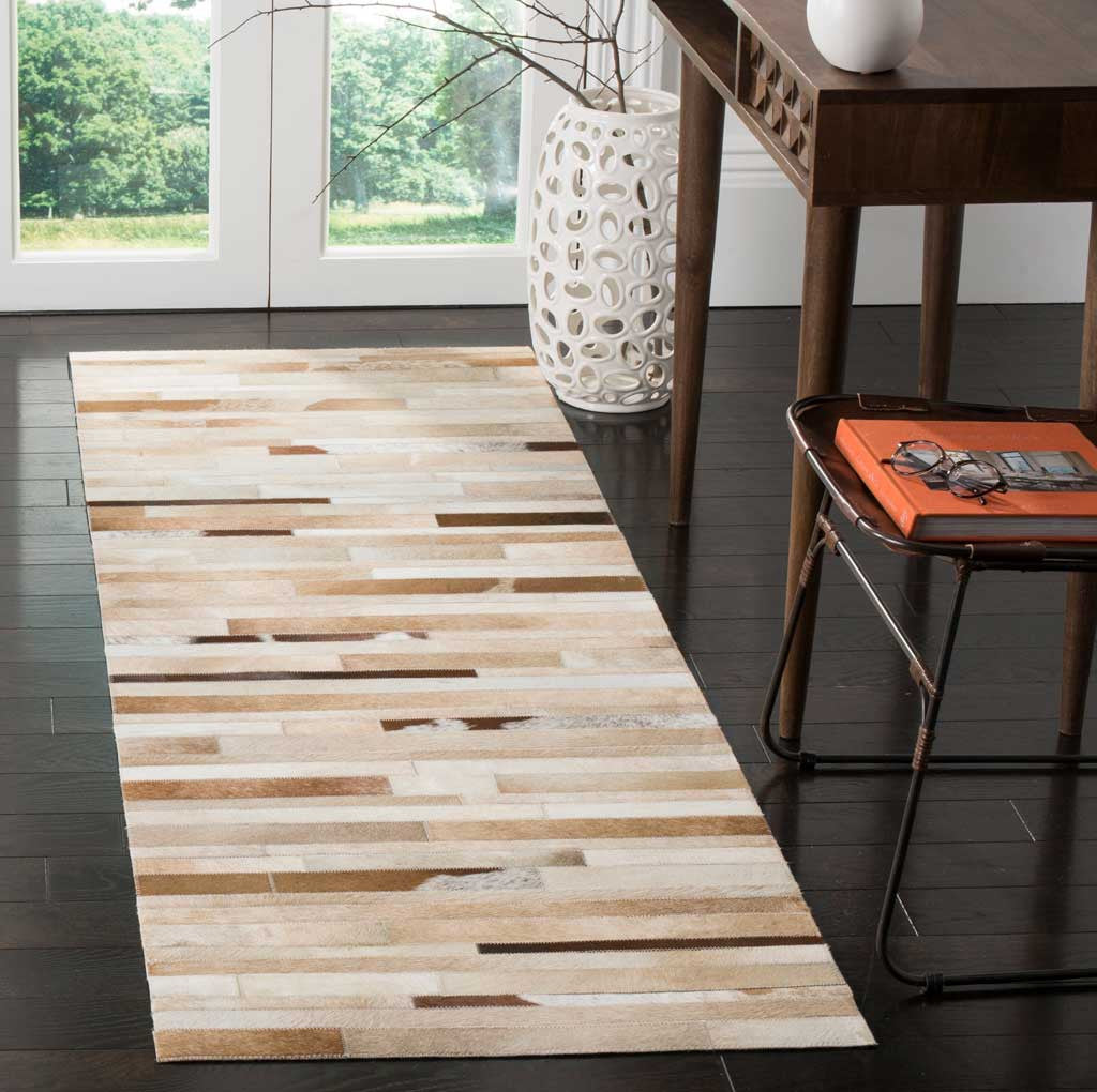 Light leather strips and scattered brown streaks create a linear pattern on this runner