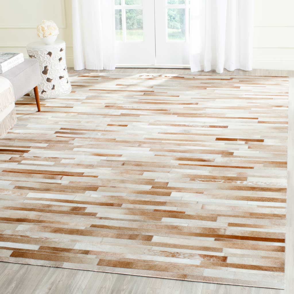Tan and ivory hide strips bring gentle color variation and texture to the floor
