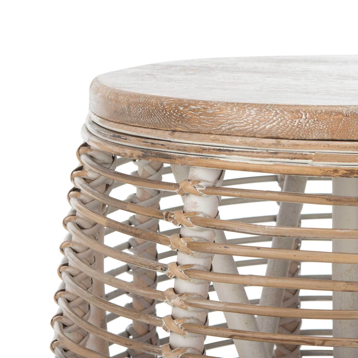 Whitewashed wood grain and knotted rattan add texture to the stool