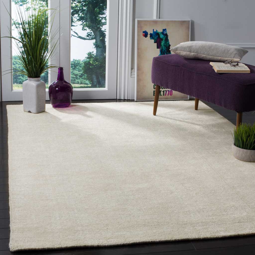Ivory rug brightens dark floors with a calm, unpatterned surface