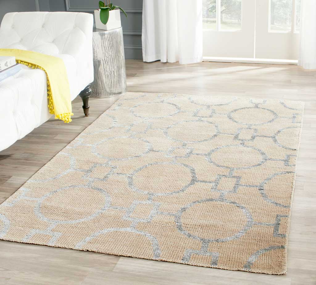 Beige rug with oversized gray rings softens a bright seating area