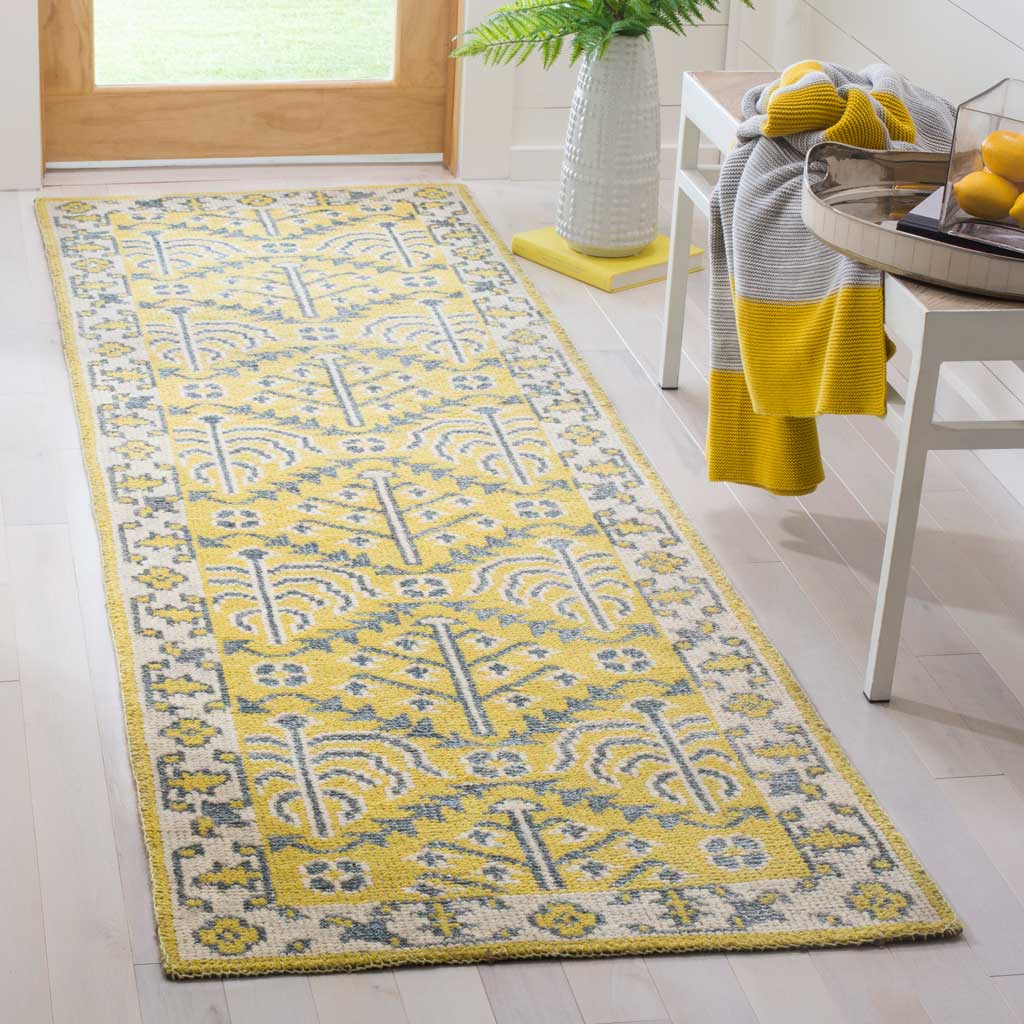 Low-profile yellow and gray runner with tree-like motifs framed by a patterned border