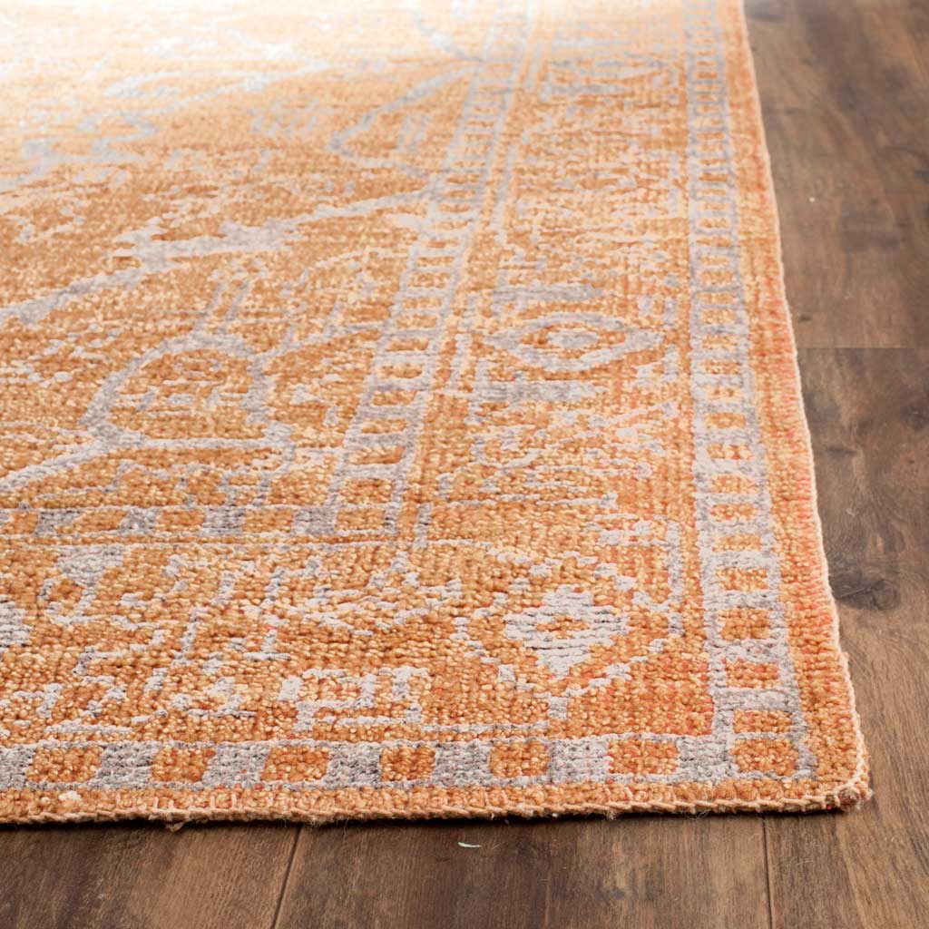 Muted silver details weave through the peach-colored border and textured pile