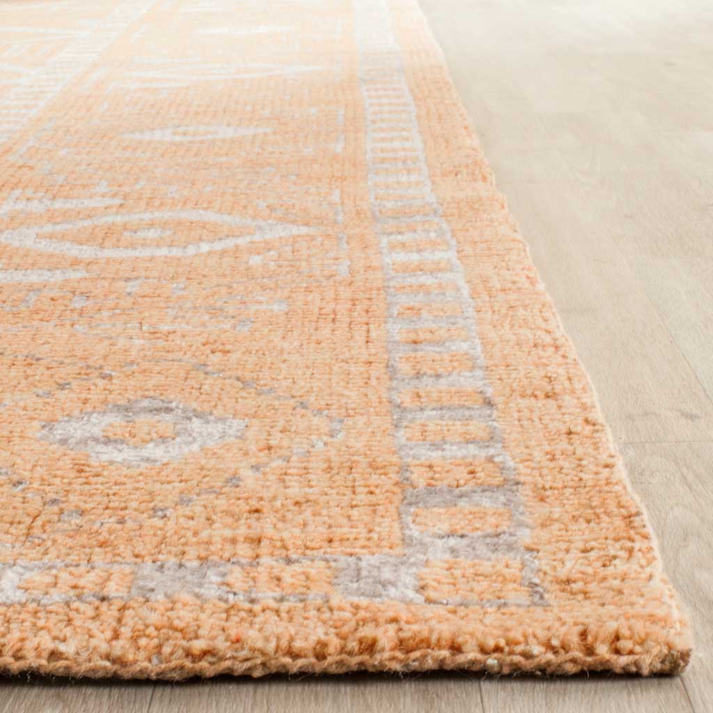 Soft apricot pile meets pale silver motifs and a plush, bound edge