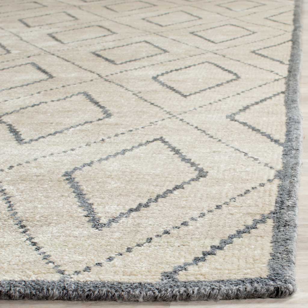 Gray diamond outlines meet a plush ivory pile and neatly finished edge