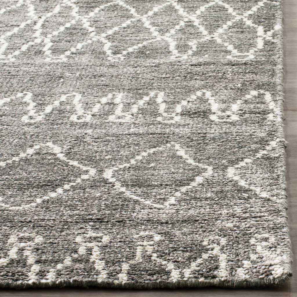 Ivory diamond motifs stand out against textured gray pile and a plush edge