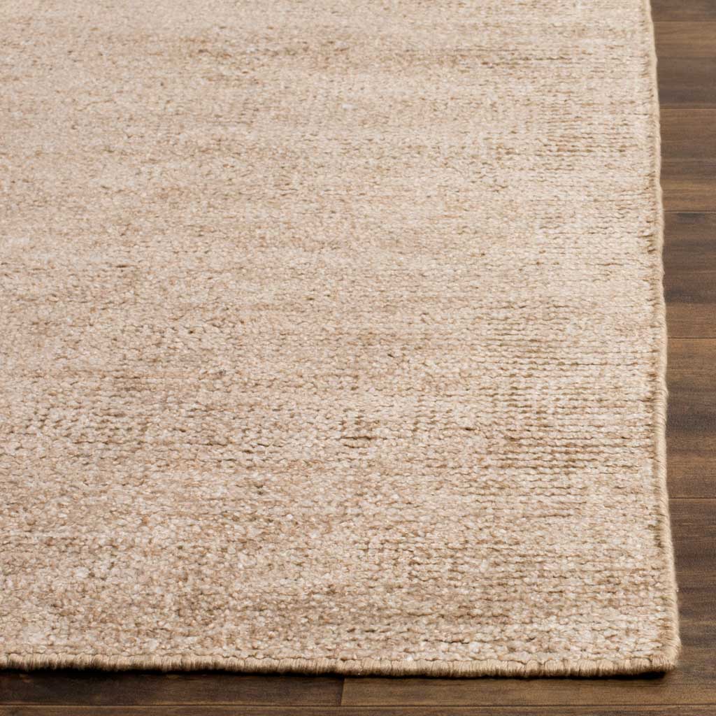 Soft beige pile and neatly finished edges add texture to this tonal rug