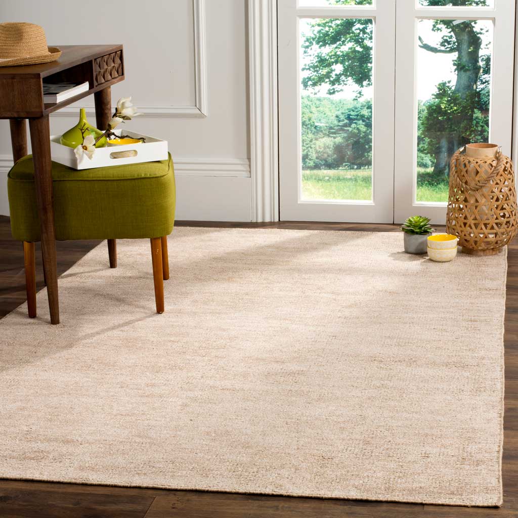 Soft beige rug brings quiet warmth to an airy space with dark wood floors
