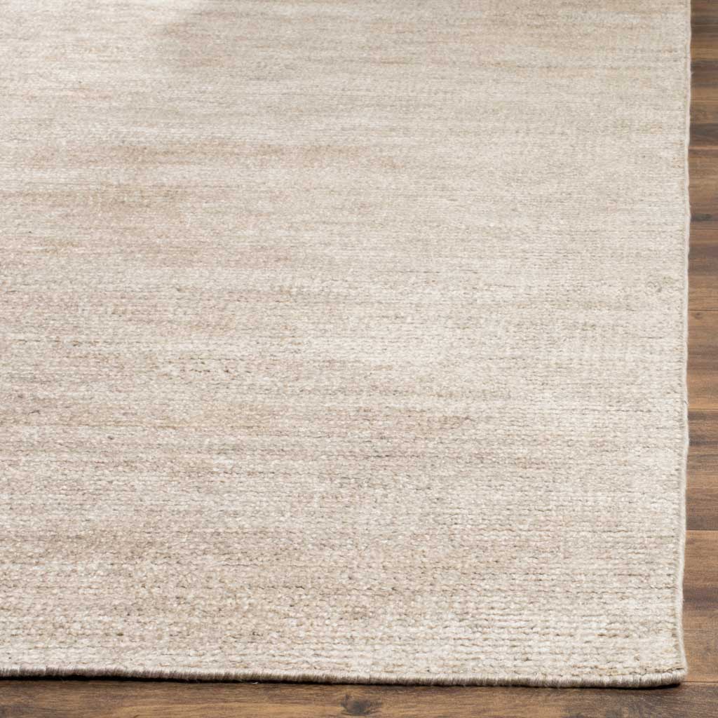 Soft gray fibers and a neatly finished edge highlight the rug's delicate texture