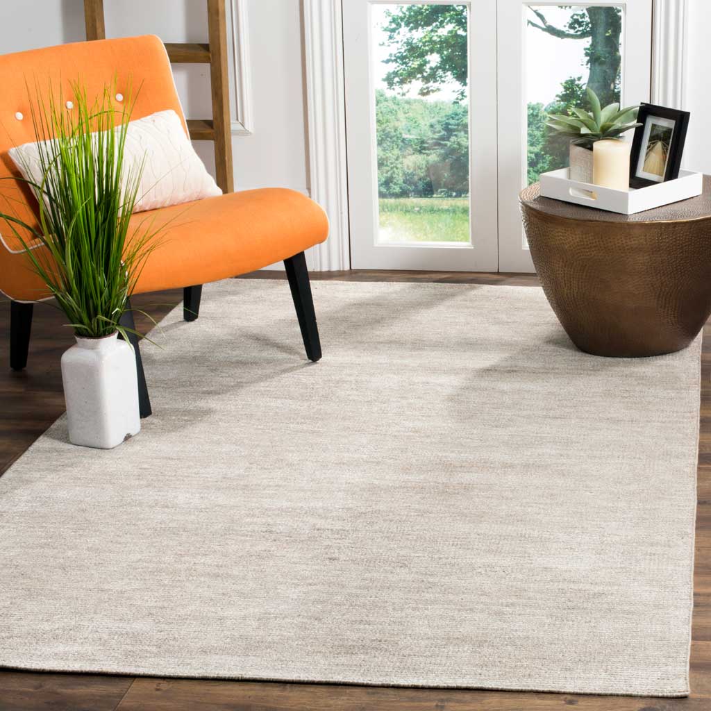 Light gray rug grounds a lively room with its softly shaded, solid-color design