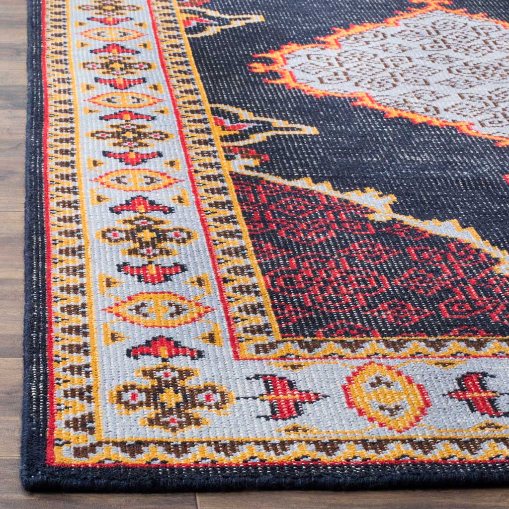 Vibrant red and golden motifs brighten the pale blue border of this dark rug