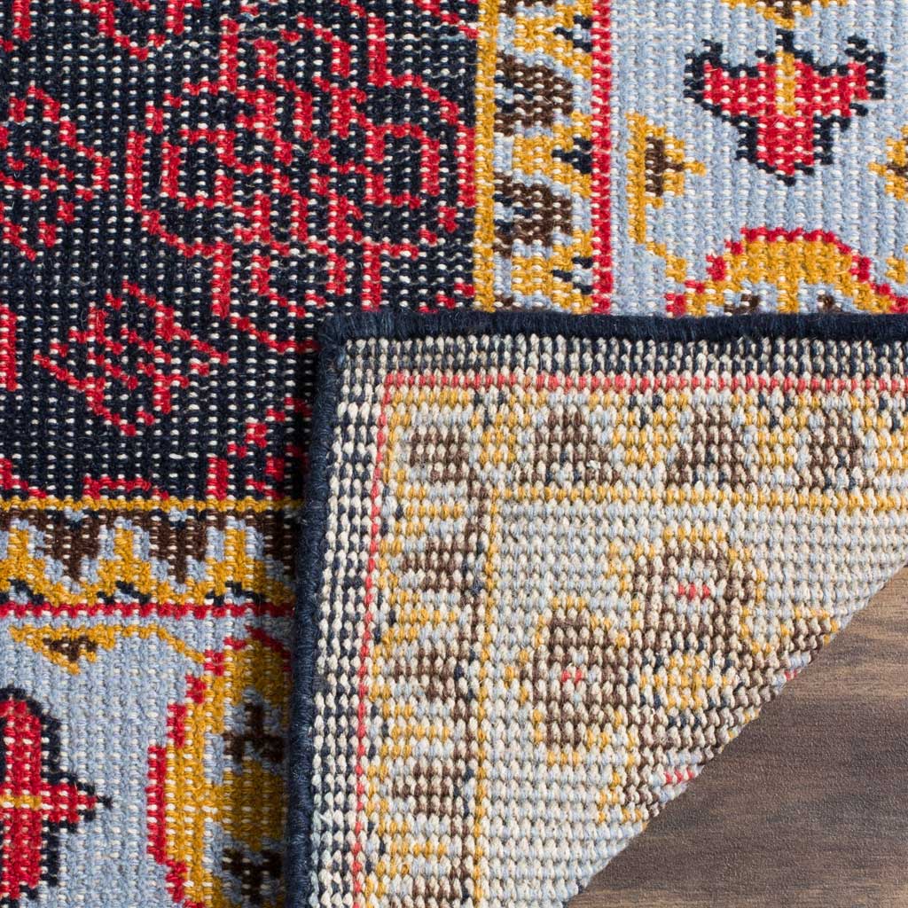 Woven underside and bound edge reveal the colorful rug's construction