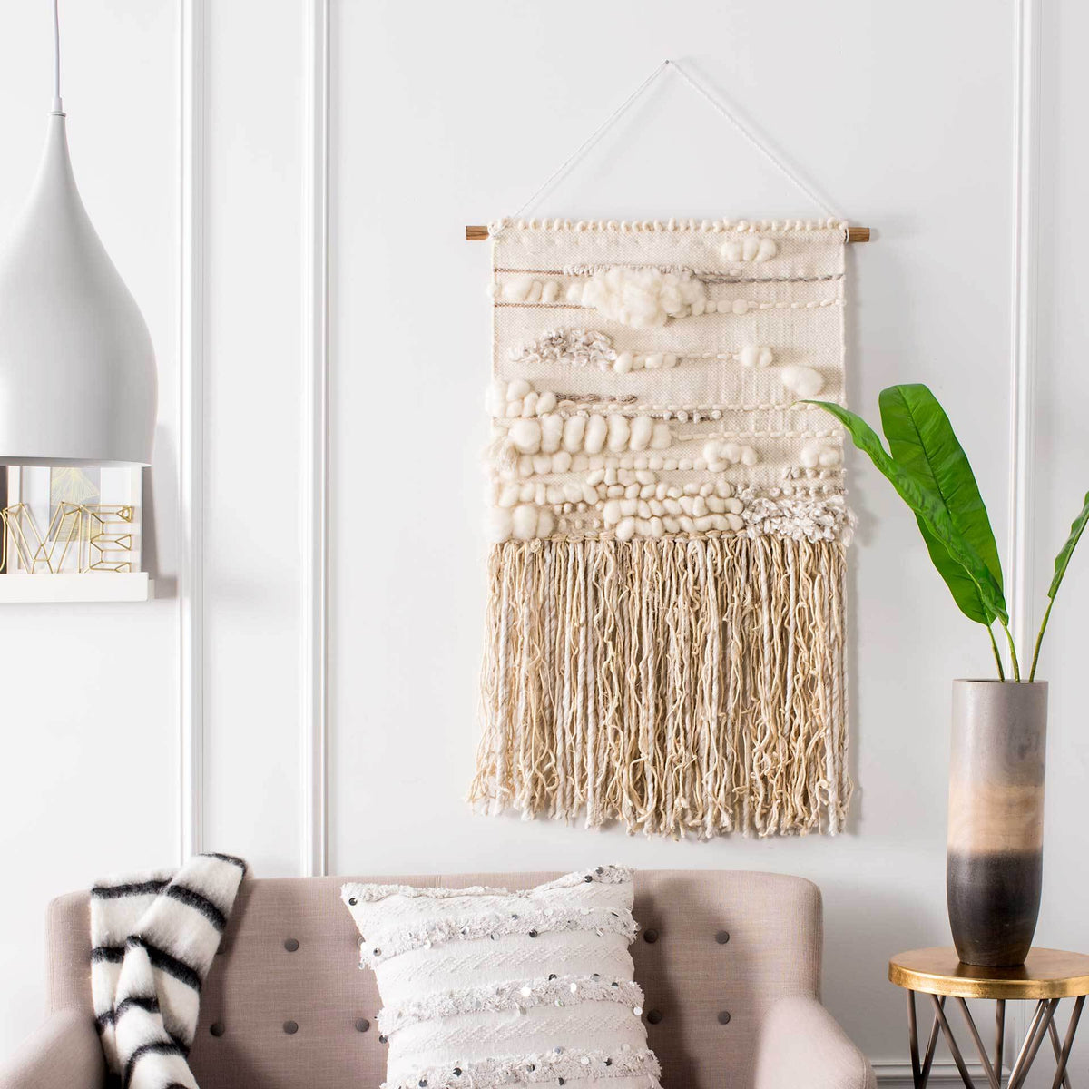 Cream wool-and-jute wall hanging pairs pillowy textured bands with long, earthy fringe.
