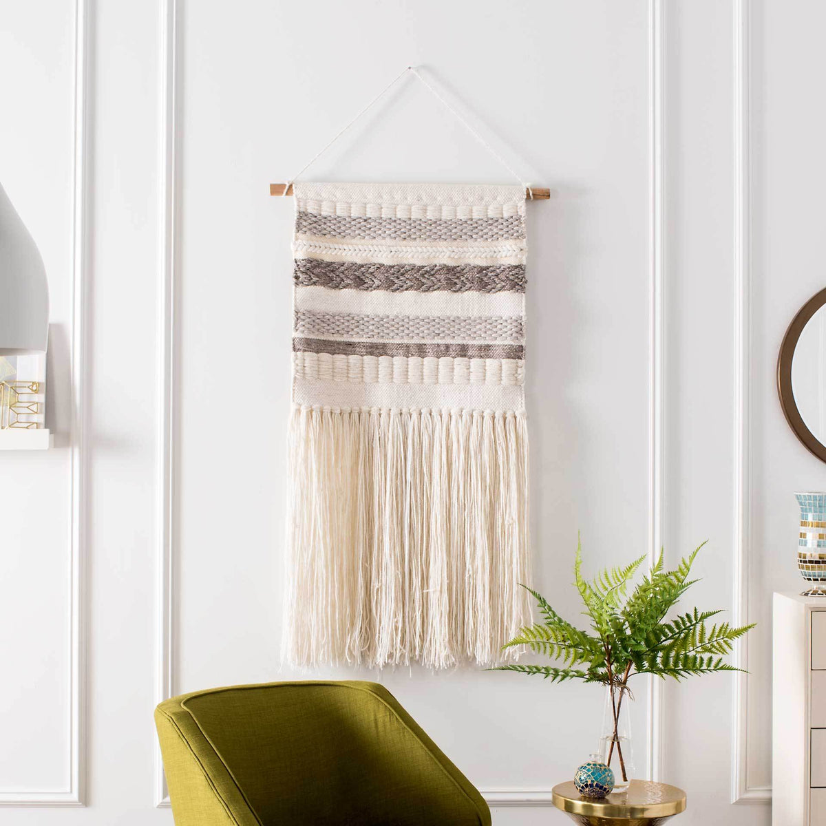 Subtle ivory-and-gray stripes add gentle contrast to this fringed woven wall tapestry.