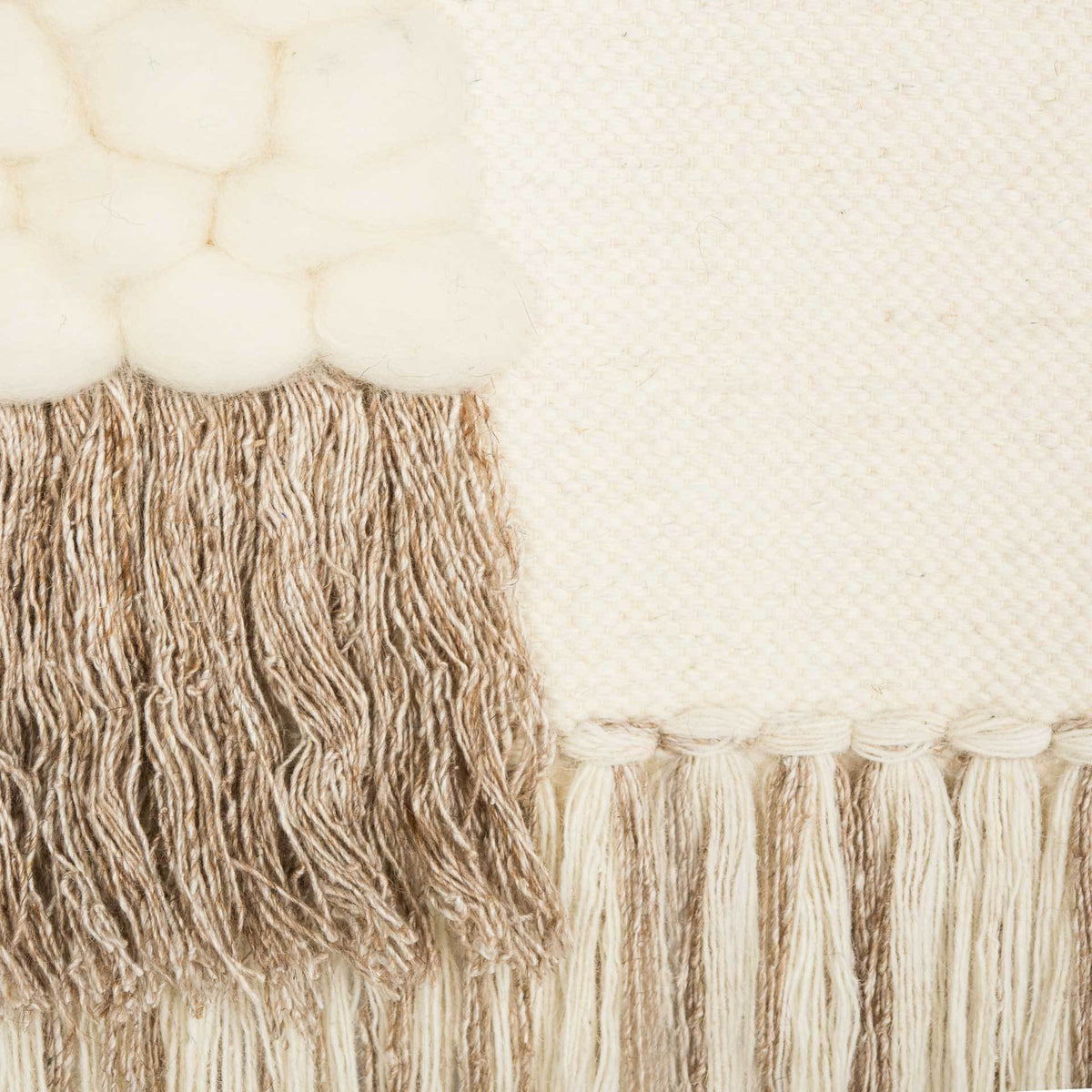 Pillowy cream wool knots meet dense beige fringe and a smooth, tightly woven ivory field.