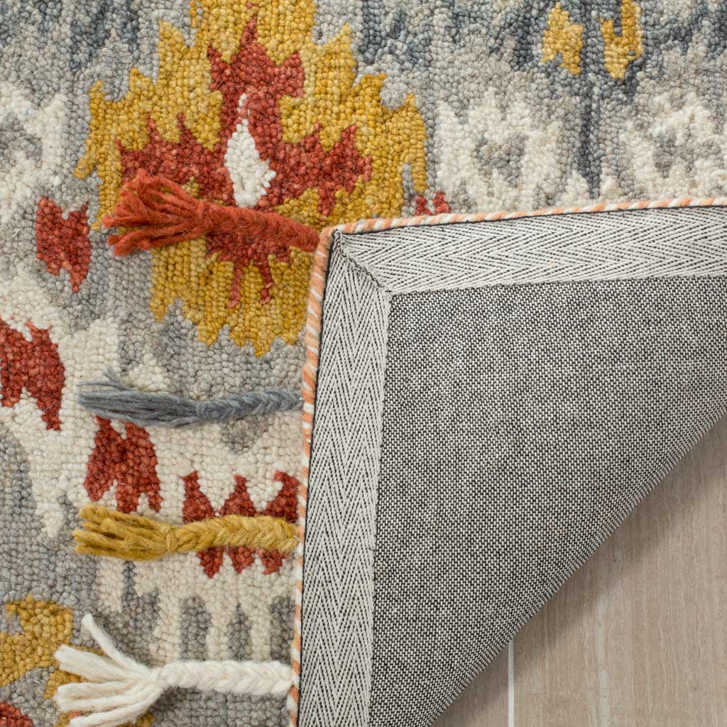 Gray woven backing and bound edges add a neat finish to the richly patterned wool rug