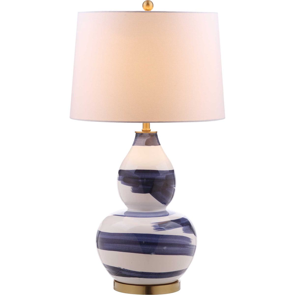 A warm glow shines through the white shade above the blue-and-white ceramic base and gold accents.