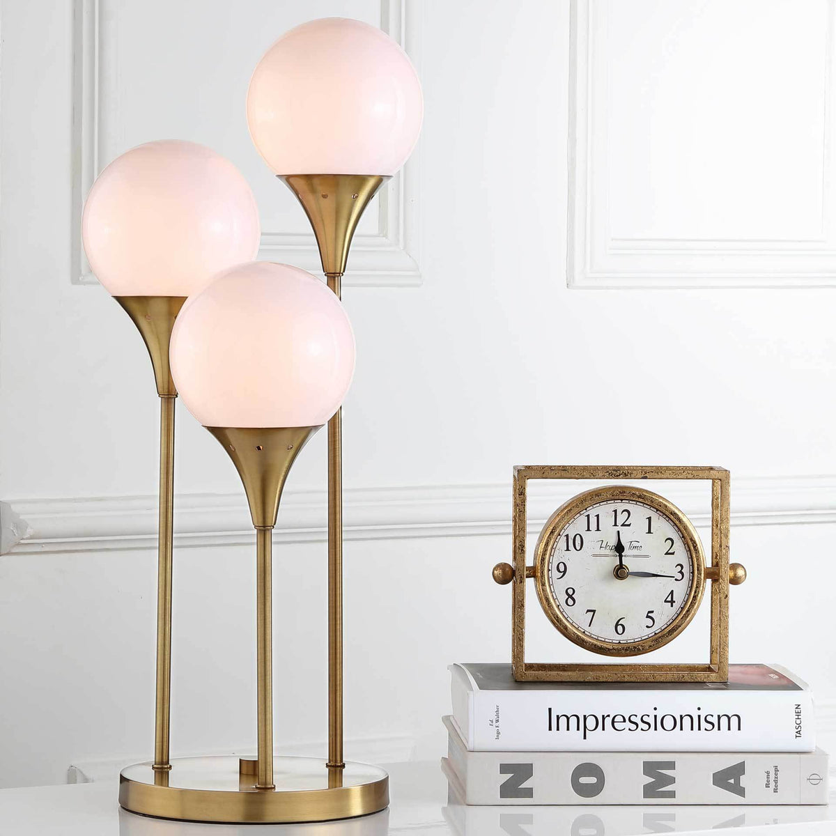 Warmly lit globes on staggered brass-finished stems create a cozy glow