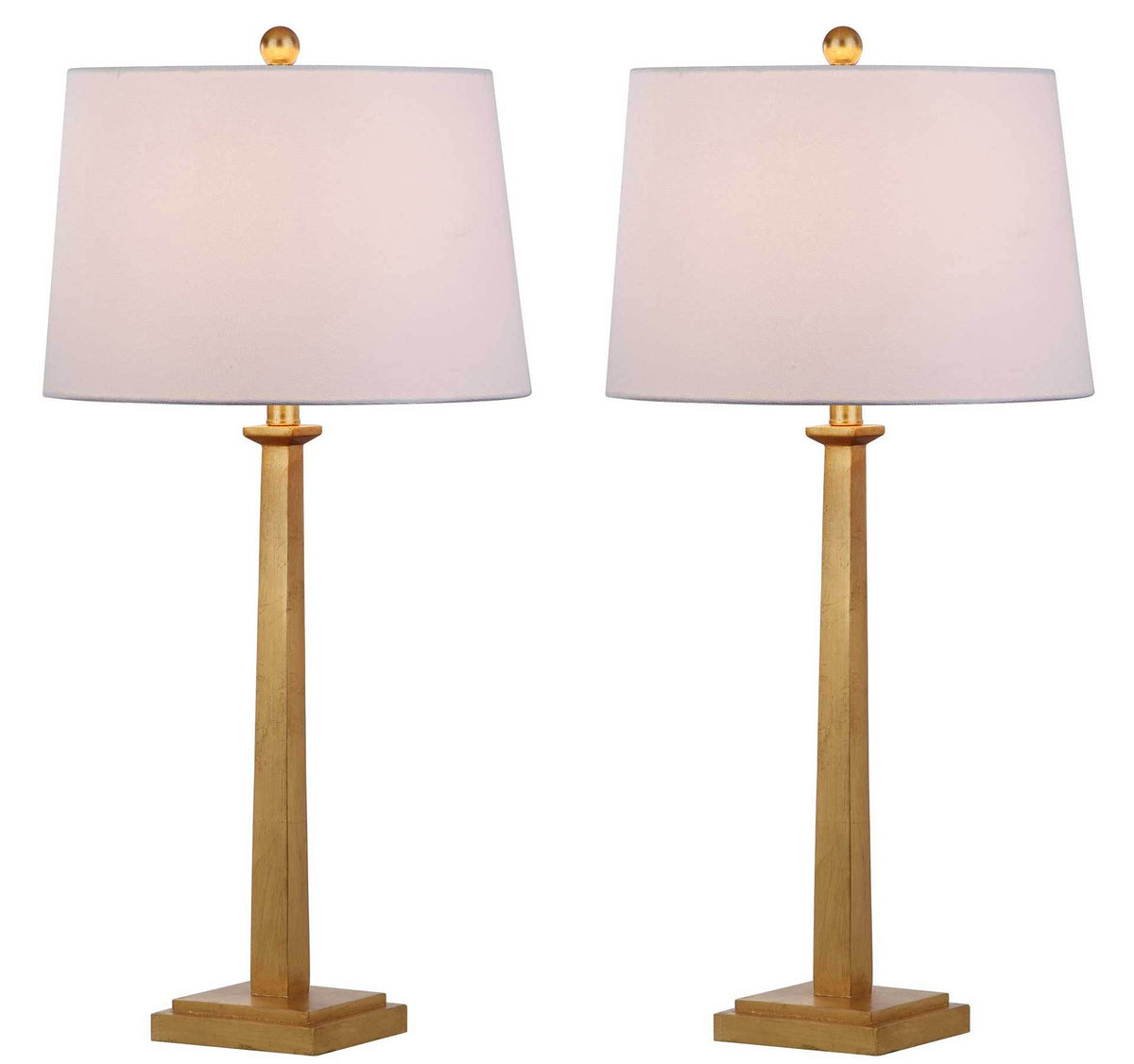 Two gold leaf table lamps cast a warm glow through their white fabric shades