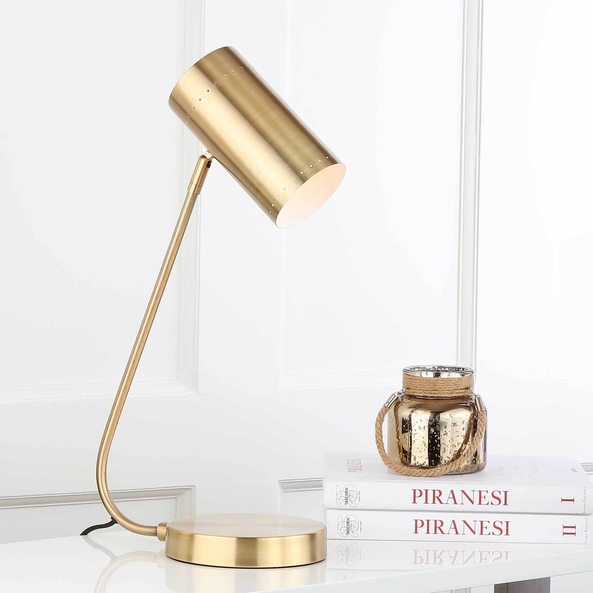 A gentle downward glow complements the lamp's curved stem and low, round base.