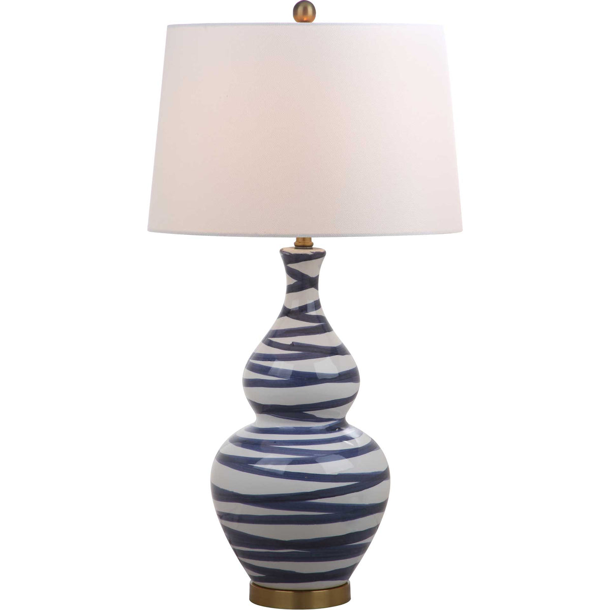 A softly glowing white shade tops a blue-striped ceramic lamp with gold accents