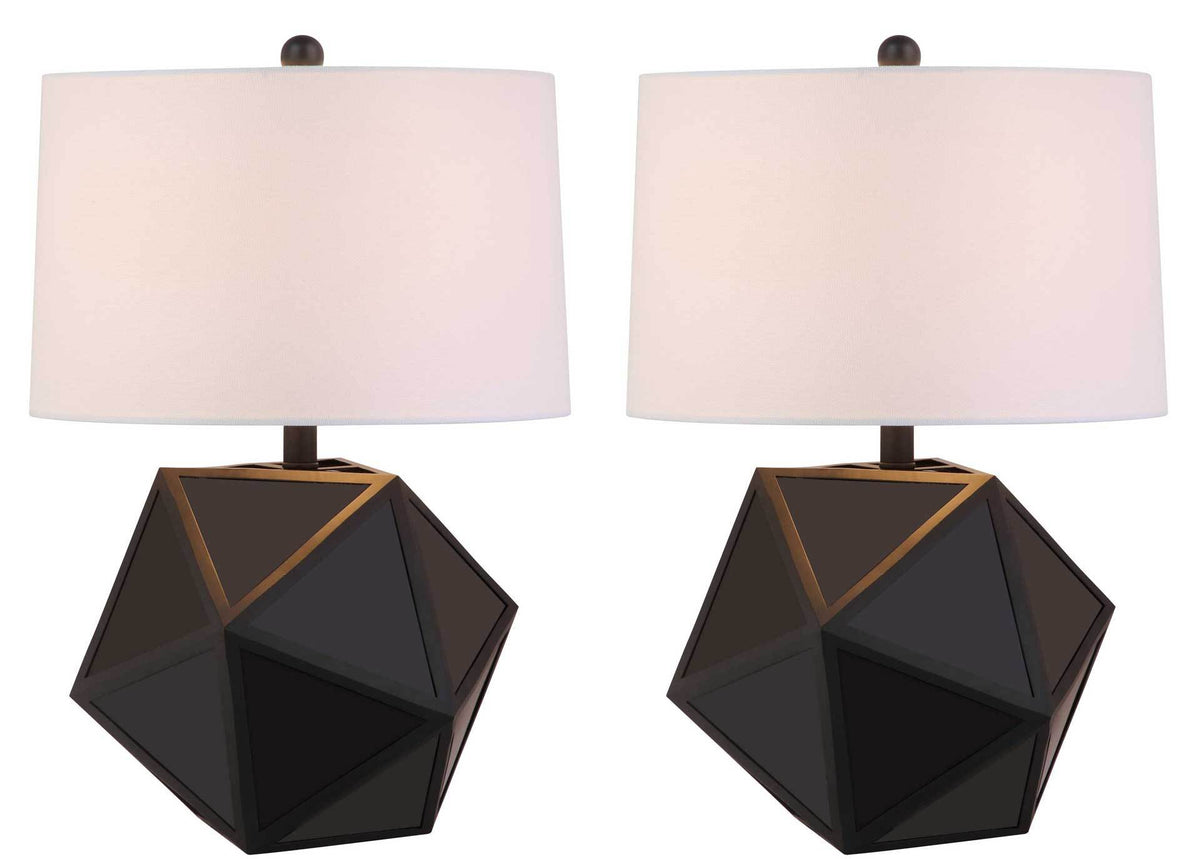 A matching pair of geometric black table lamps glows warmly through white fabric shades.