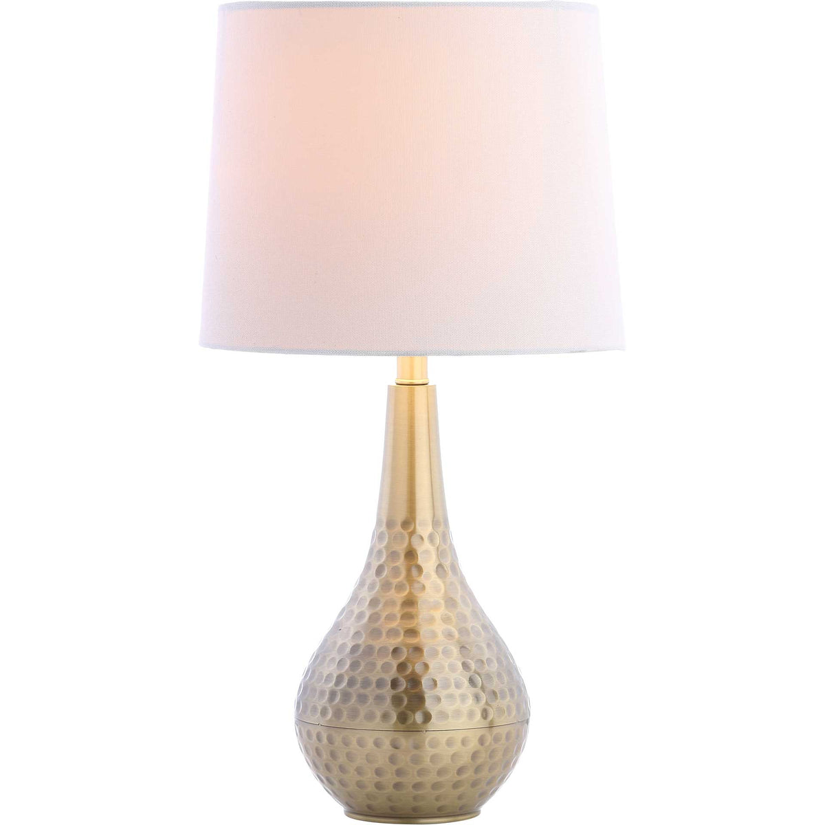 Warm light glows through the white shade atop a sculptural gold metal base