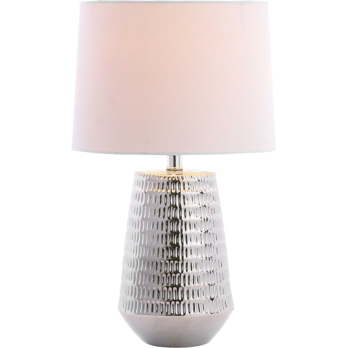 Warm light glows through the white shade above a reflective, patterned silver base.