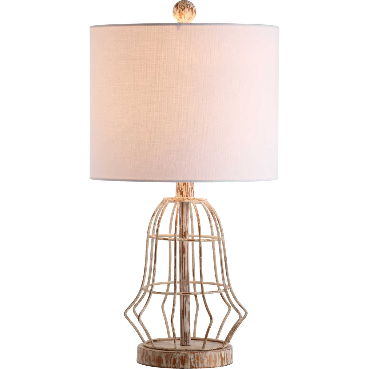 Warm light glows through the white fabric shade above a sculptural openwork iron base.
