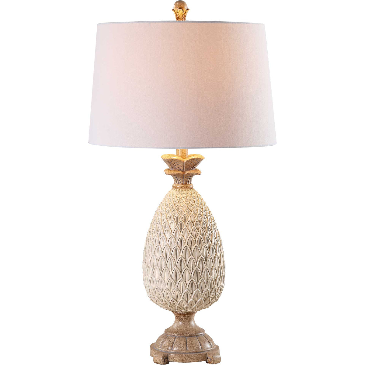 A warm glow illuminates the white shade above a textured cream base and brown pedestal