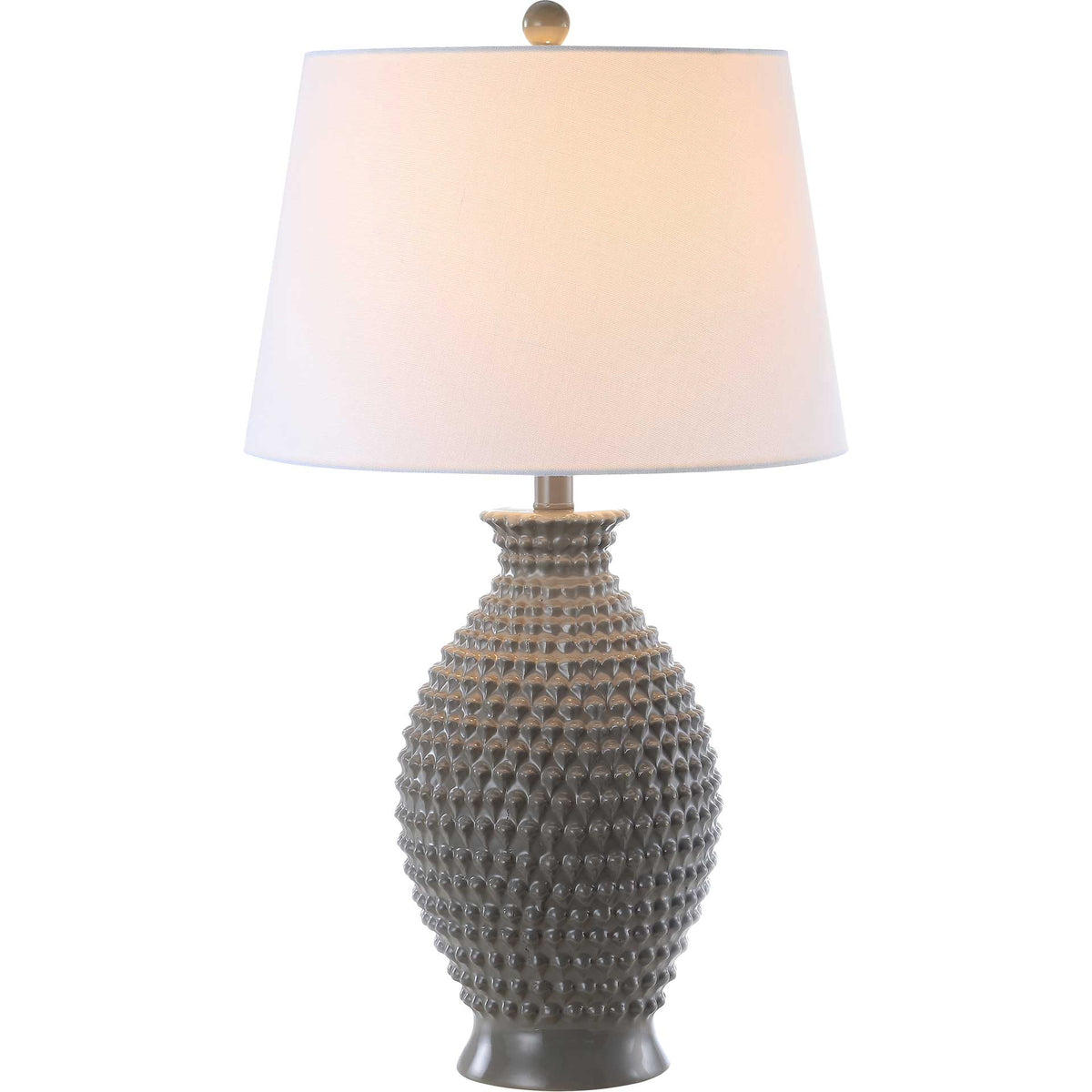 Warm light glows through a white shade above a textured gray polyresin base