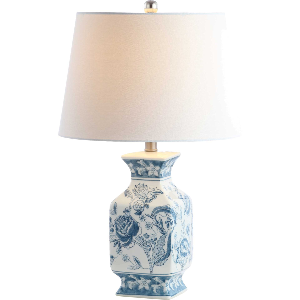 Warm light shines through a white shade above an ornate blue-and-white ceramic base