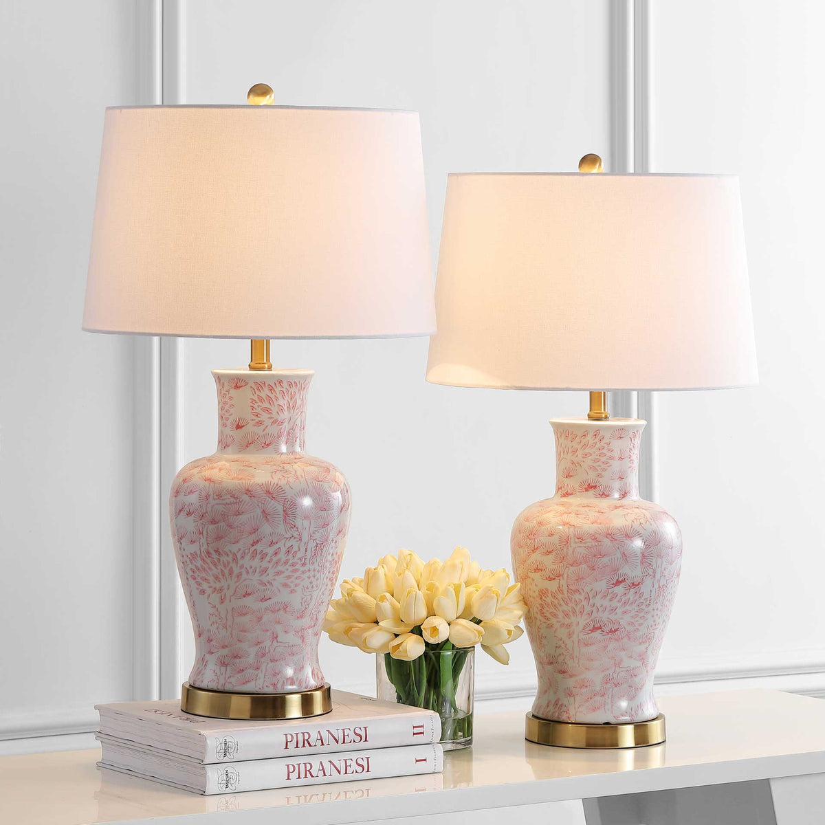 Two pink floral ceramic table lamps cast a warm glow through white fabric shades