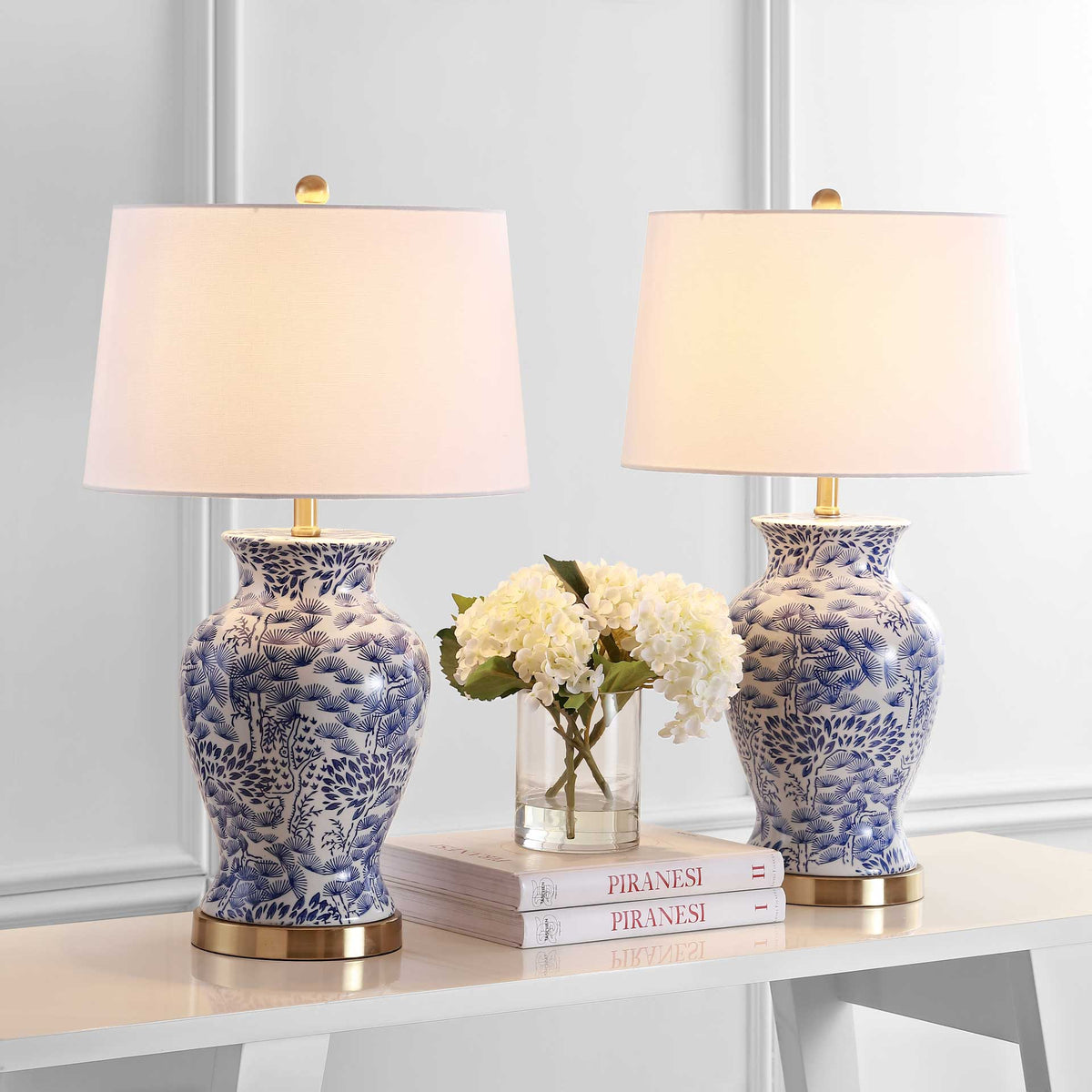 A matching pair of ceramic lamps casts a warm glow above blue-and-white patterned bases
