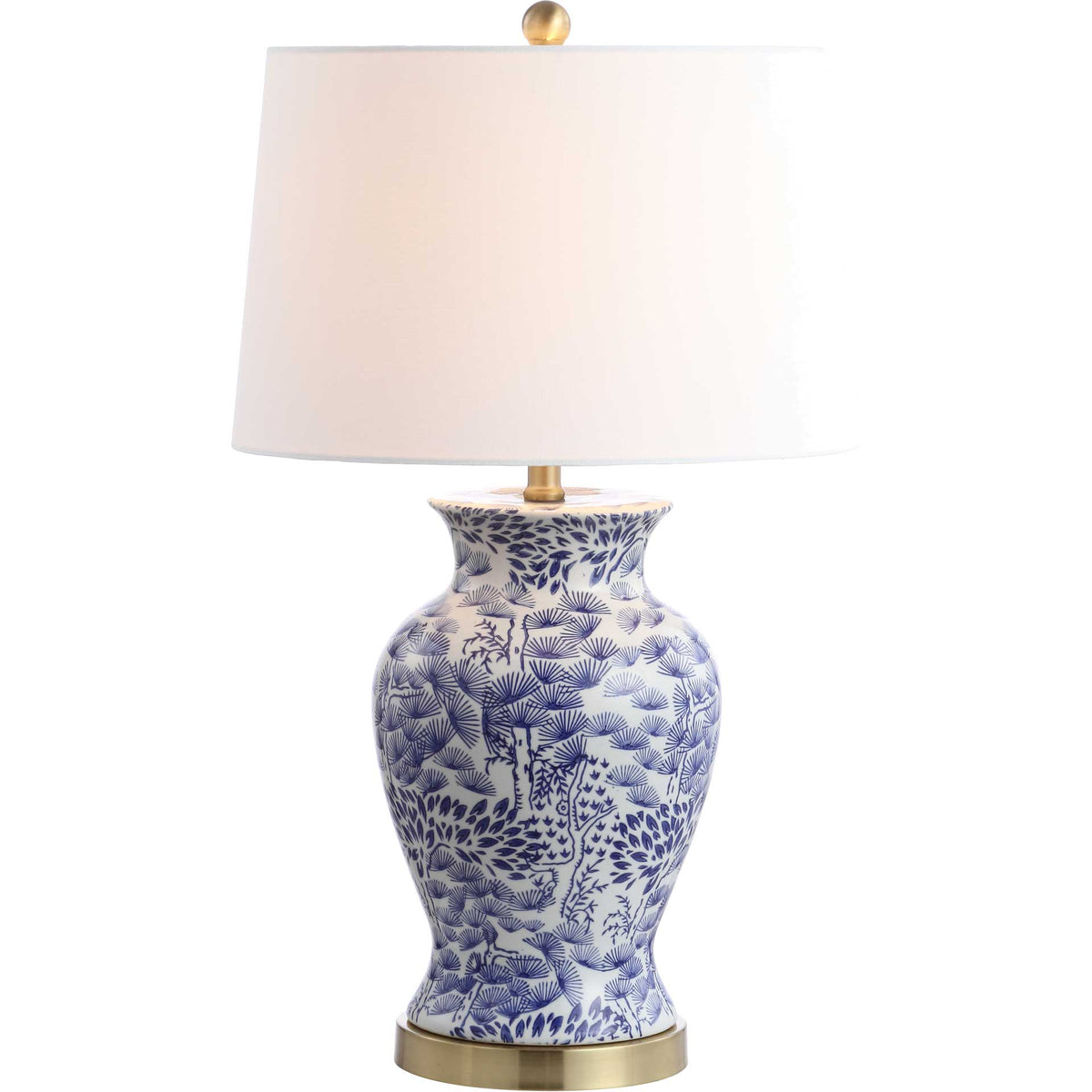 Warm light glows through a white shade above a patterned blue-and-white ceramic base