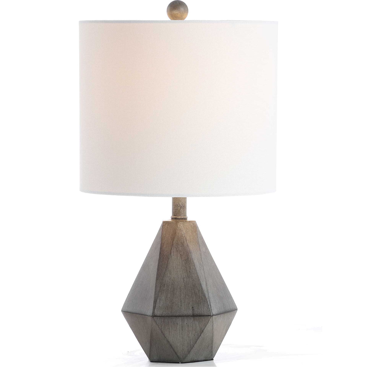 A softly glowing white shade warms the faceted dark gray base of this table lamp.
