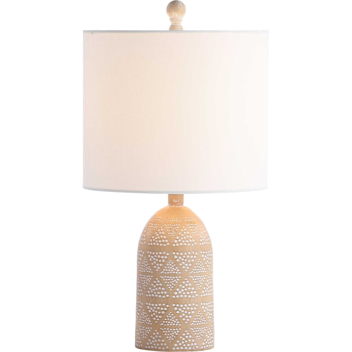 Warm light glows through a white drum shade above a patterned sand-colored resin base