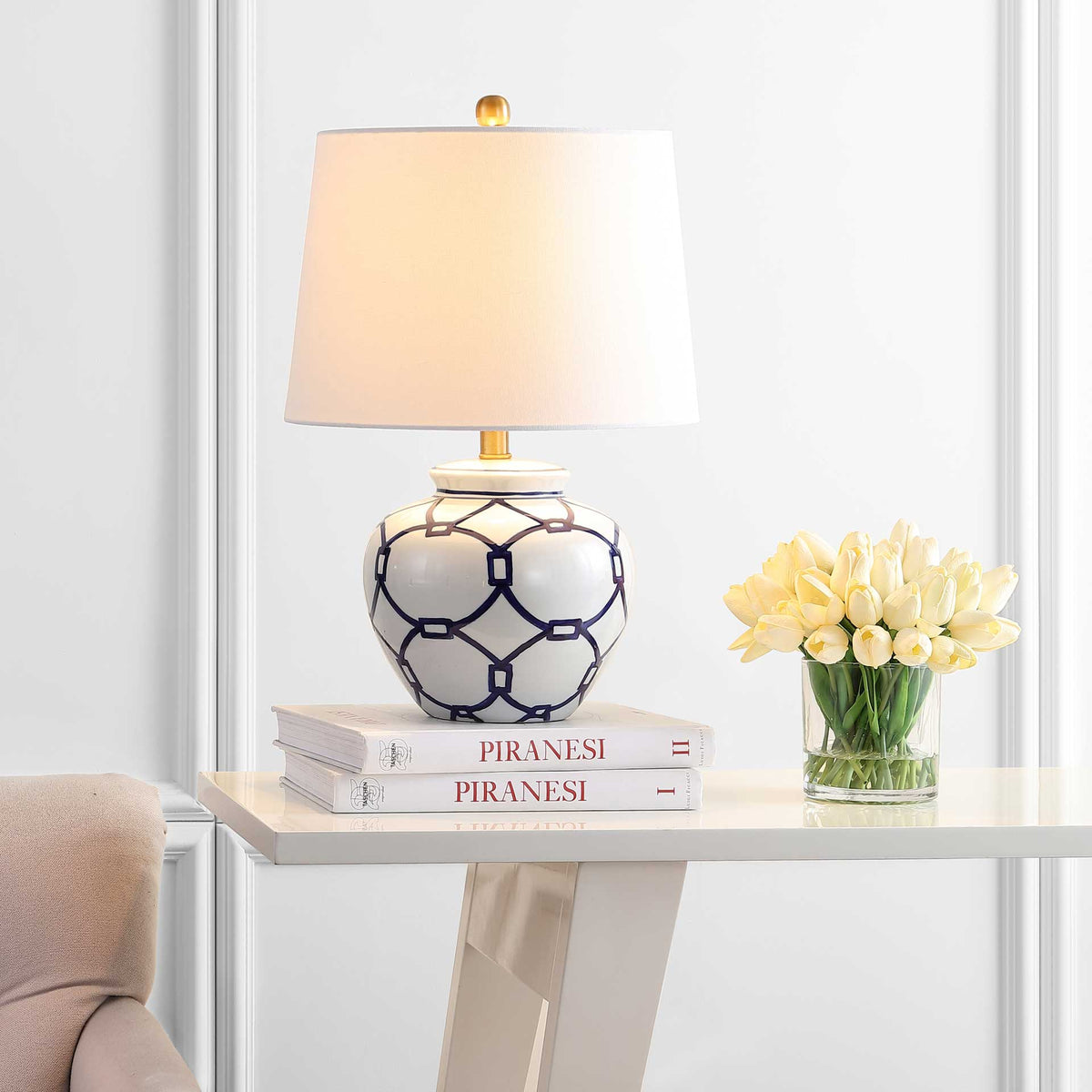 Warm light glows through a white shade above the blue and white patterned ceramic base