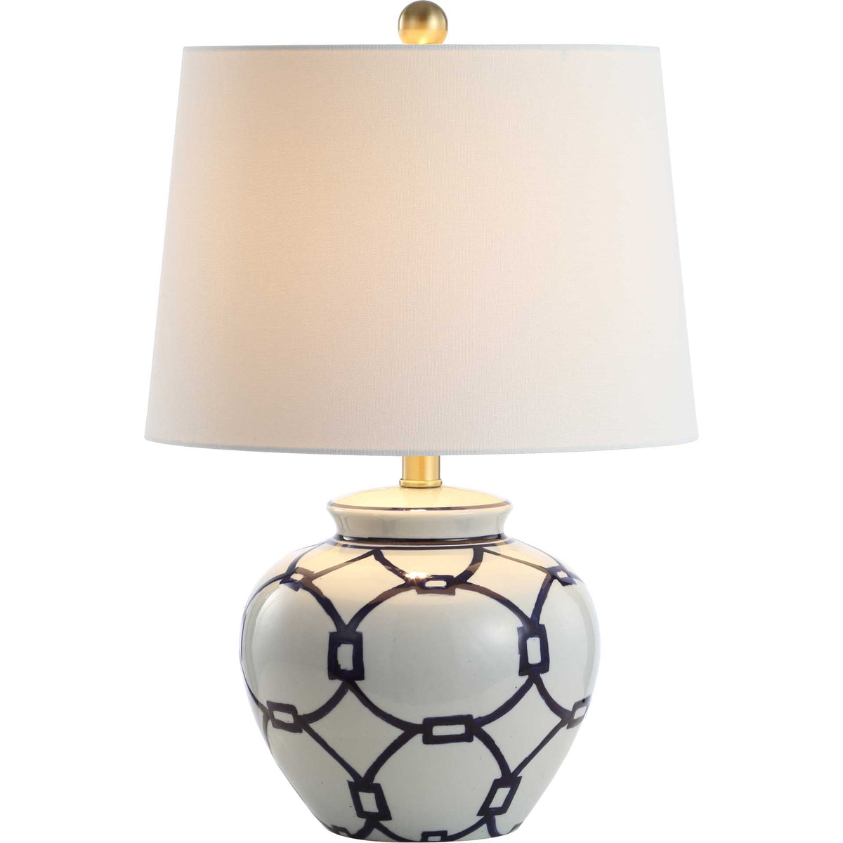 A softly glowing shade crowns a rounded blue and white ceramic base with bold linked motifs